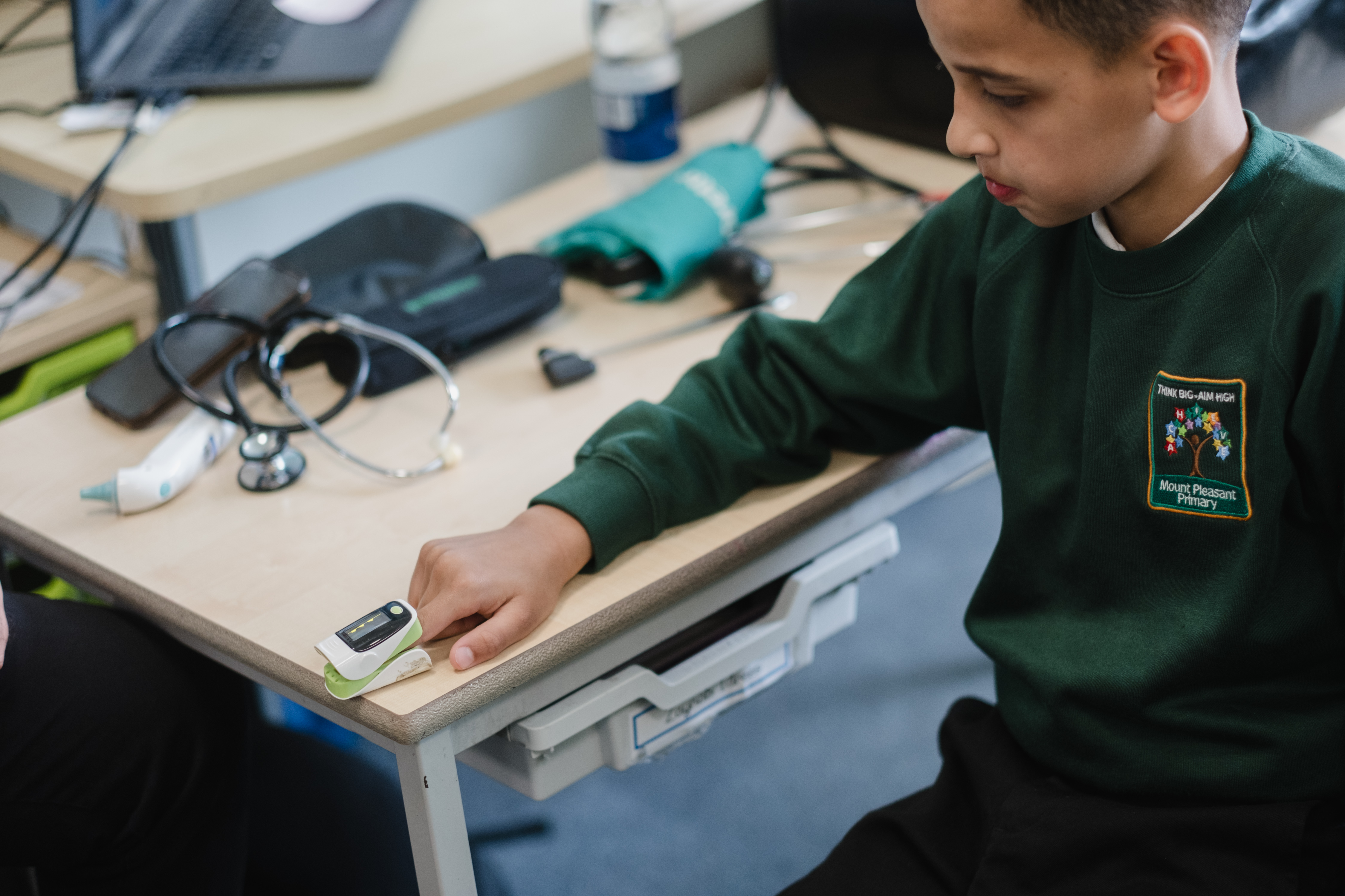 School child using oximeter